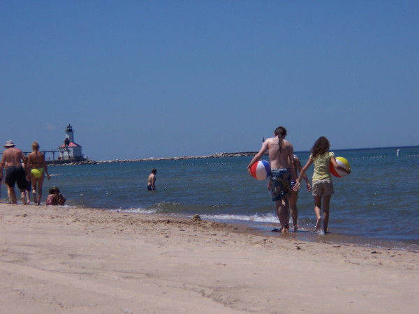 Playing on the Washington Park beach . . . the lighthouse is in the distance.